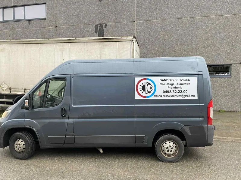 Plaque magnétique publicitaire posée sur la portière d'une camionnette pour un service de chauffage.